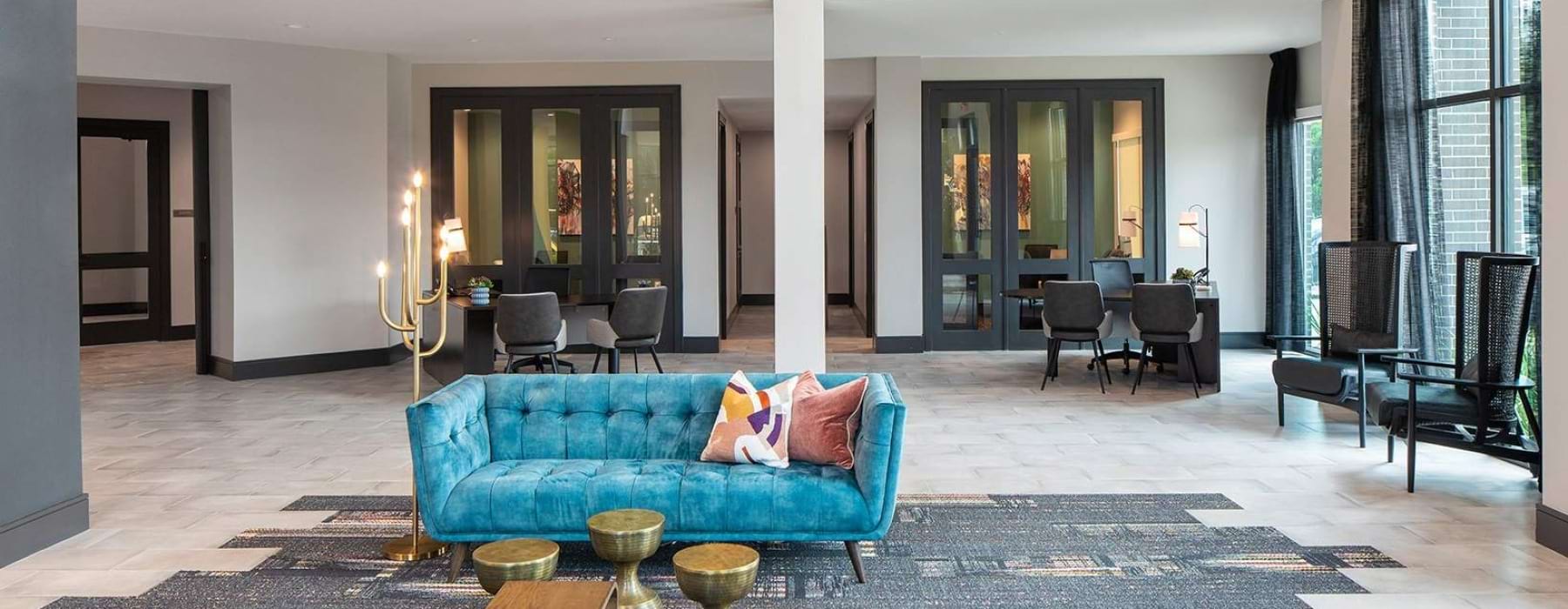 Community lounge with couch and large windows