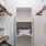 Closet with shelving, robes, and baskets