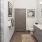 Bathroom with double sinks and glass shower